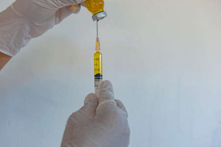 Image of Hand holds Coronavirus Covid-19 Vaccine glass bottle.の写真素材