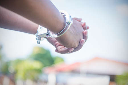Close up. Hands are handcuffed. captured prisoner or terrorist, close-up of hands in handcuffs.の写真素材