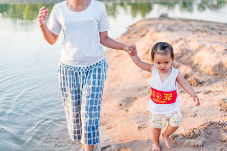 Mother and daughter play on the beach.