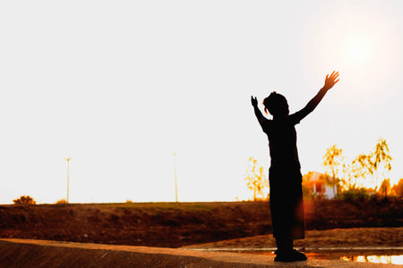 Silhouette side girl looking up Feel rejuvenated by the warm light and sky.