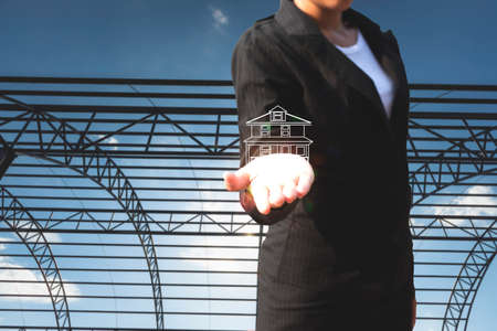 Business woman holding real estate icon building. Engineering and construction. investment and...