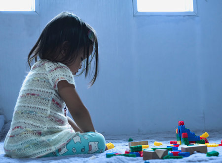 Asian woman builds a house from plastic blocks The concept of promoting the development of kindergarten children.の写真素材
