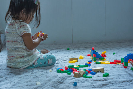 Asian woman builds a house from plastic blocks The concept of promoting the development of kindergarten children.の写真素材