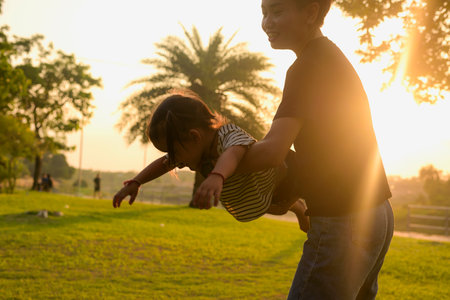 Silhouette, diversity of young women and girls walking in the park with LGBTQ family. Family...