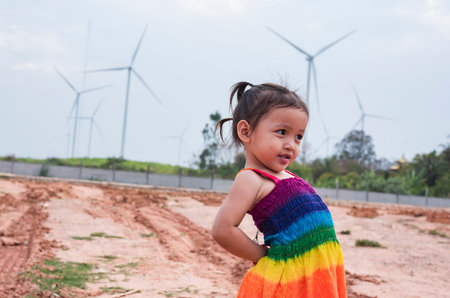 Asian girls study wind turbines to generate electricity. Sustainable energy. future.の写真素材
