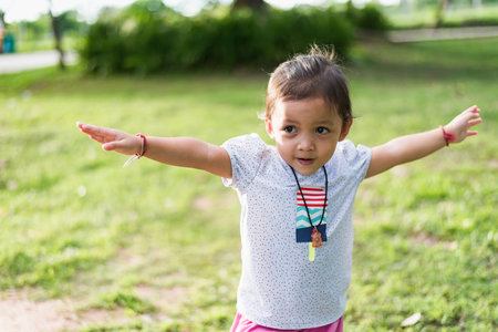 Child doing exercise on platform outdoors. Healthy lifestyle. Yoga girlの写真素材