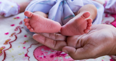 Baby feet in hands, mother, mother and her baby, happy family concept, beautiful conceptual image of childbirth.の写真素材