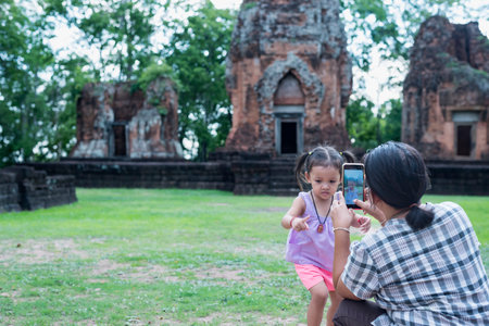 Close-up of mother taking picture of her daughter while enjoying a day in nature.