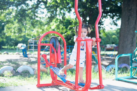 Children playing on a summer day Playground in the park Children's entertainment and recreation.の写真素材