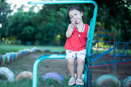 Children playing in the park at playground.の写真素材