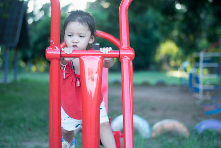 Children playing in the park at playground.の写真素材