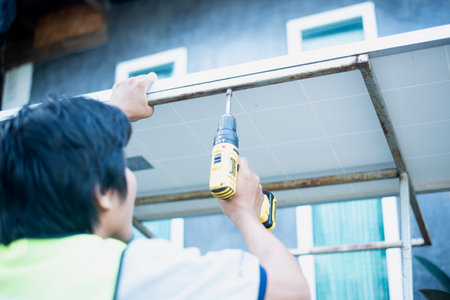 An electrician or homeowner can inspect, improve, and repair and maintain rooftop solar panels in the home themselves.の写真素材