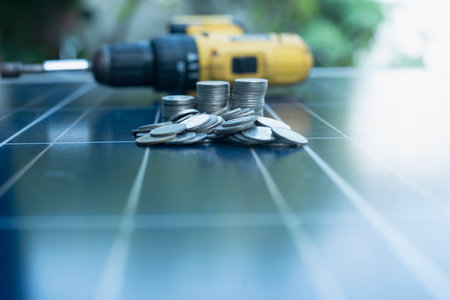 Stack of coins on solar panel The idea of installing solar cells gives you more money and more left over for savings.の写真素材
