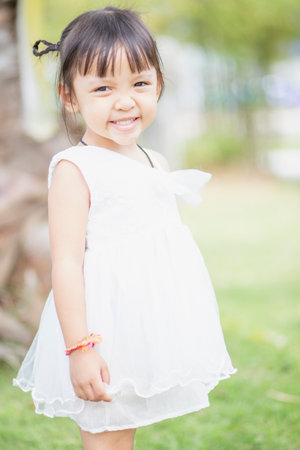 Portrait of a young Asian girl smiling at the camera - Happy Thai girl having fun posing.の写真素材