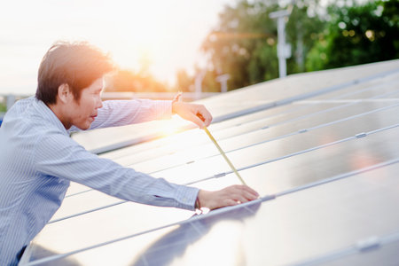 Female electrical engineering team installs and inspects solar photovoltaic panels. Clean and environmentally friendly alternative energy.の写真素材