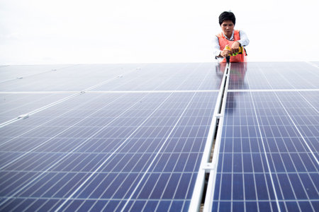 Male electrician installs solar panels solar energy Clean and environmentally friendly alternative...