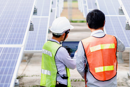 Female electrical engineering team and worker seller install solar photovoltaic panels Clean and environmentally friendly alternative energy Unity and teamwork.の写真素材