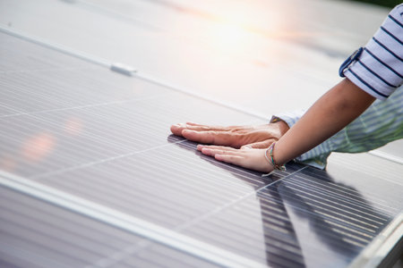 Father and daughter on a solar farm filled with solar panels. Solar energy for future generations...