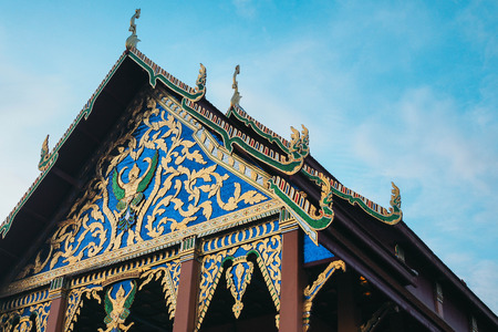 Thai temple roof and blue sky on eveningの写真素材