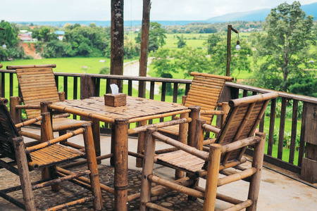 Wooden table set in gardenの写真素材