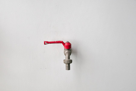 Faucet on the white wall