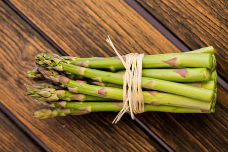 Heap of Asparagus Sprouts isolated on Rustic Wooden backgroundの写真素材