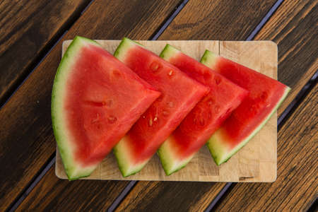 four Waater melon slices on wooden tableの写真素材
