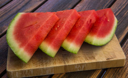 four Waater melon slices on wooden tableの写真素材