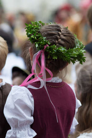Clouse-up spring portrait beautiful girl with wreath of flowersの写真素材