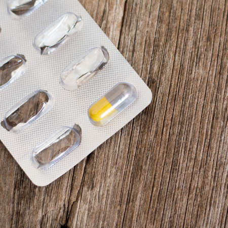 packing of capsules medicines on wooden background.の写真素材