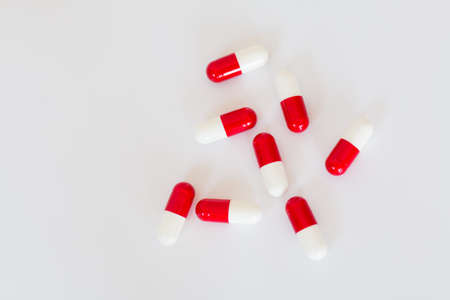 Medical white with red pills on white background.の写真素材