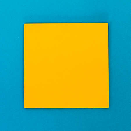 yellow empty note paper with blue background.