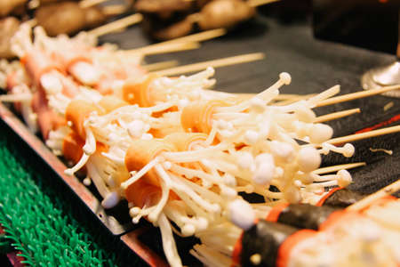 Grilled Enoki Mushroom Wrapped with Slice of Carrotsの写真素材