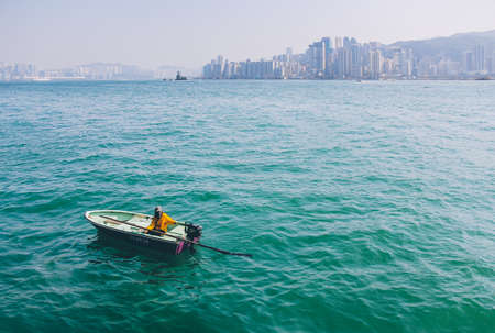 Hong Kong, China - January 01, 2014: Dinghy Boat in Victoria Harbour beside Avenue of Starsのeditorial素材