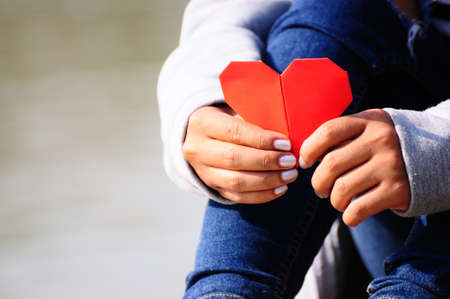 Hands Holding a Red Heart Shapeの写真素材