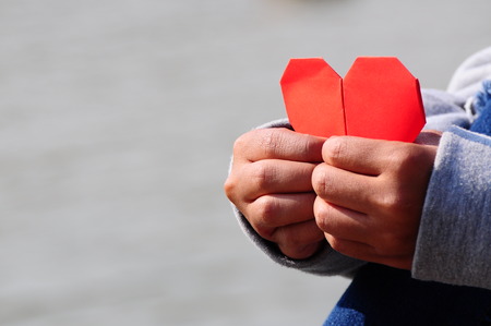 Fall in Love with Red Heart Paper in Handsの写真素材