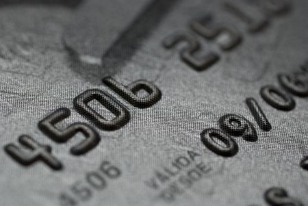 CLOSE UP OF A SILVER CREDIT CARDの写真素材