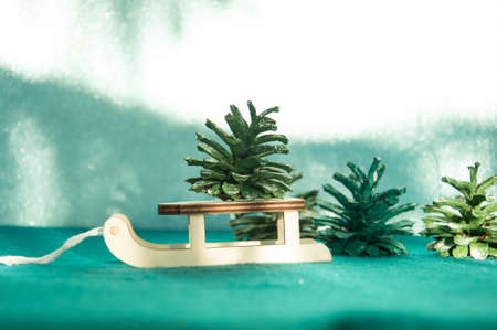 Christmas tree on a wooden sled on a green background. Christmas conceptの写真素材
