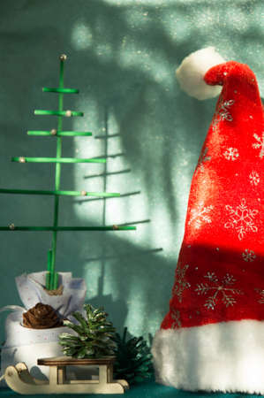 Santa hat and Christmas tree on a green background with copy space.の写真素材