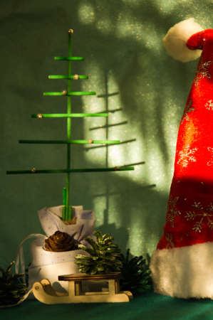 Santa Claus, Christmas tree and a toy on a green background.の写真素材