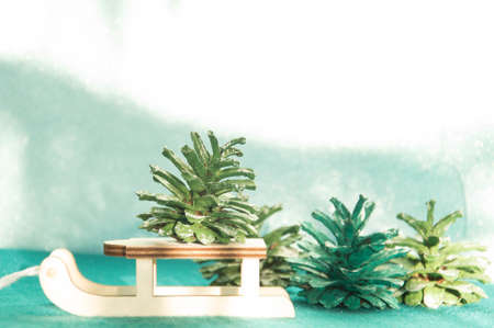 Wooden sledge with Christmas decoration on a turquoise backgroundの写真素材