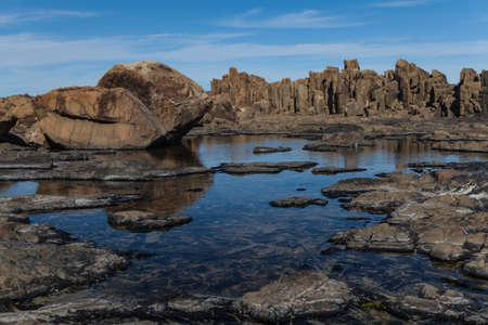 Bombo Headland Quarry Australia. Blue skies and reflections in waterの写真素材