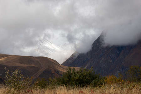 Kazbegi region of Georgia, snow capped mountains and rugged terrainの写真素材