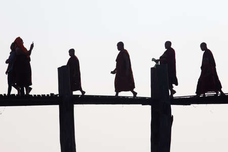 Silhouettes of local people walking on u bien bridge Mandalay, Myanmarの写真素材