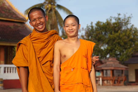 Ban Houei Sai Laos 12/23/2011 Smiling happy young Buddhist monks in orange robesのeditorial素材