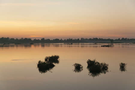 Muong Khong Laos 1/12/2012 Mekong river at dawn with golden sun rise over waterの写真素材