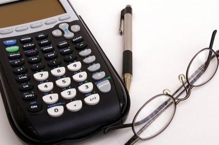 Calculator, pen, and glasses on a white background