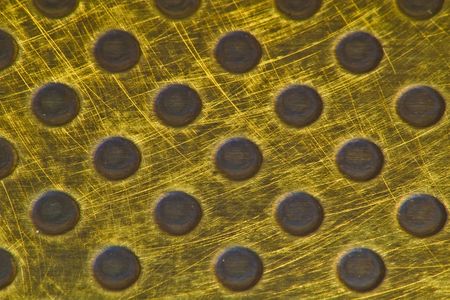 Acid etched punched brass metallic background textureの写真素材