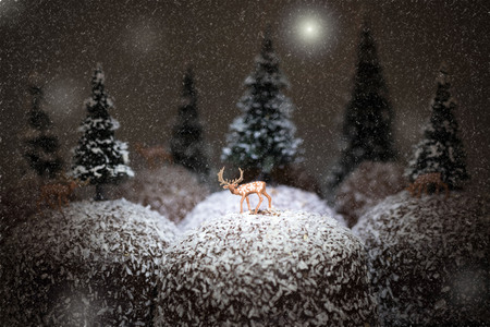 winter landscape, deer on chocolate covered cream cakeの写真素材