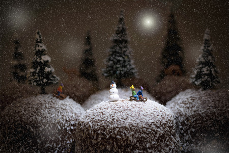children sledging on chocolate covered cream cake
